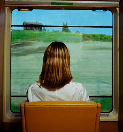 Norway --- Woman Looking Out Train Window --- Image by © Julius/CORBIS
