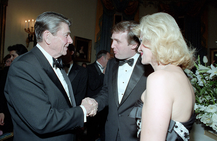 2/11/1985 President Reagan shaking hands with Donald Trump and Ivana trump during the State Visit of King Fahd of Saudi Arabia at the state dinner in the Blue Room
