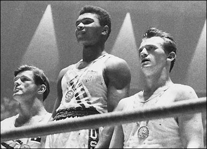 The winners of the 1960 Olympic medals for light heavyweight boxing on the winners' podium at Rome: Cassius Clay (now Muhammad Ali) (C), gold; Zbigniew Pietrzykowski of Poland (R), silver; and Giulio Saraudi (Italy) and Anthony Madigan (Australia), joint bronze. (Photo by Central Press/Getty Images)