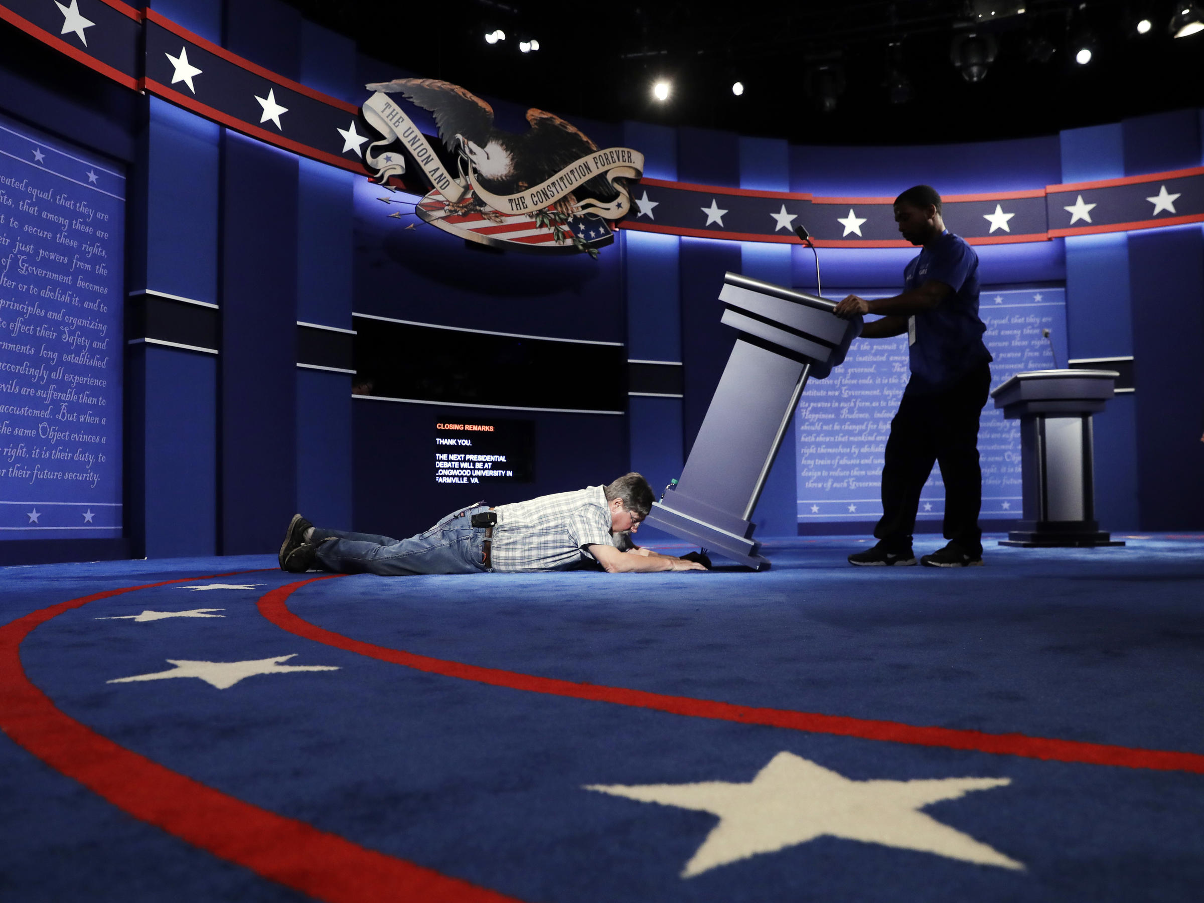 Technicians set up the stage for the Sept. 26 presidential debate between Democratic presidential candidate Hillary Clinton and Republican presidential candidate Donald Trump at Hofstra University in Hempstead, N.Y.